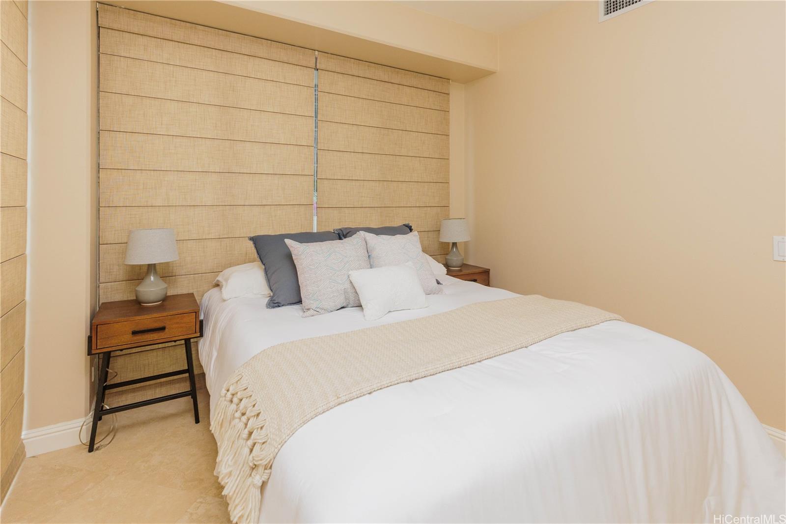 225 Queen Street, Unit 7A Honolulu, HI 96813 - Photo 9 of 18 a bedroom with a bed and a shower