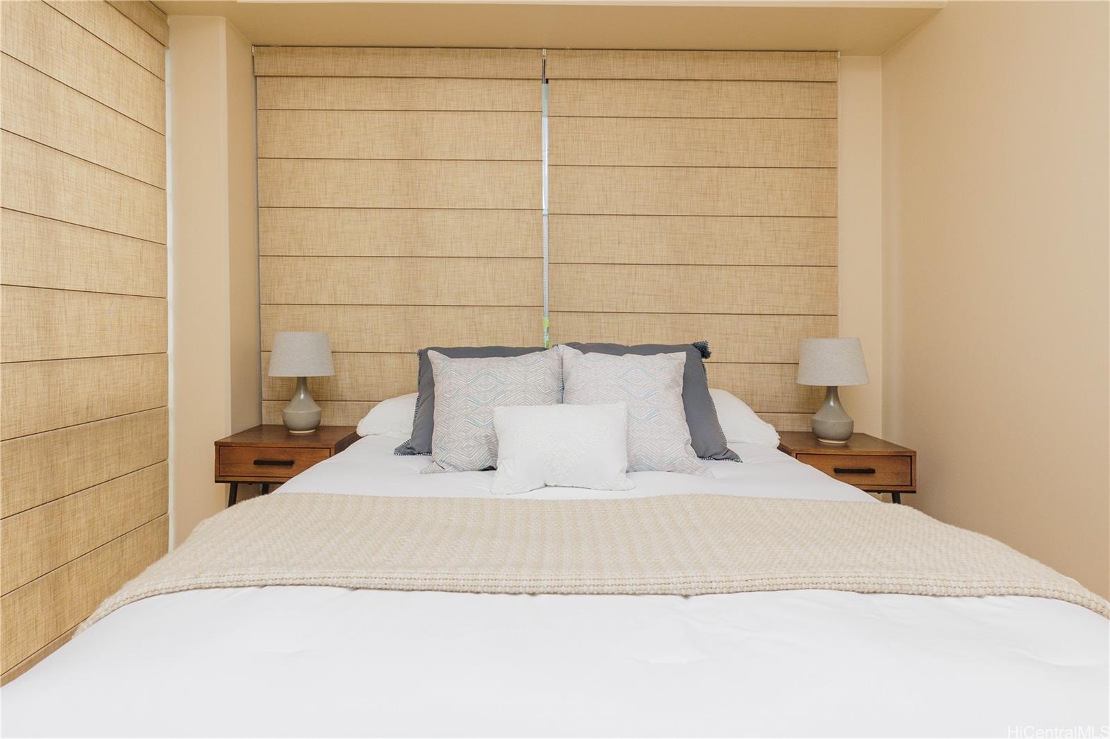 225 Queen Street, Unit 7A Honolulu, HI 96813 - Photo 10 of 18 a large bed sitting in a bedroom next to a wall