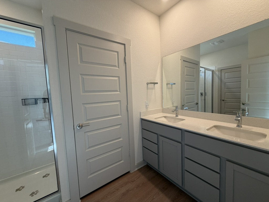 10708 Gonzales Ranger Pass Austin, TX 78754 - Photo 13 of 40 Double vanity with ample storage and a sleek shower create a tranquil daily routine.