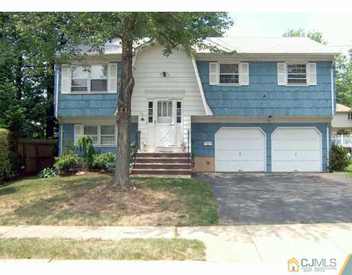 36 Maiden Way Colonia, NJ 07067 - Photo 1 of 8 a front view of a house with a yard and garage