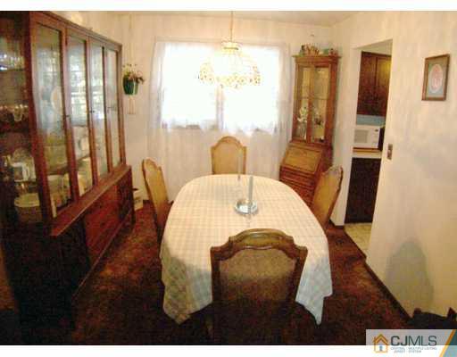 36 Maiden Way Colonia, NJ 07067 - Photo 3 of 8 a view of a dining room with furniture window and wooden floor