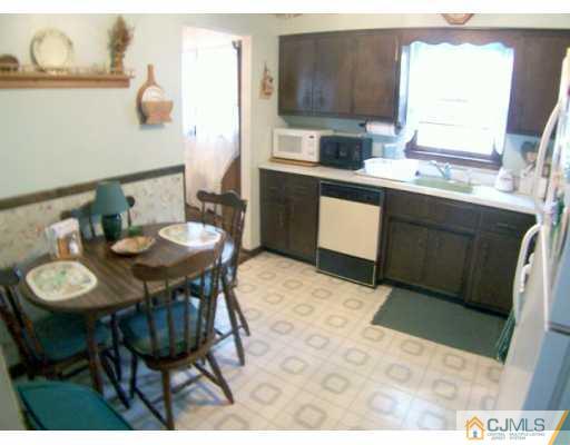 36 Maiden Way Colonia, NJ 07067 - Photo 4 of 8 a kitchen with a table and chairs in it