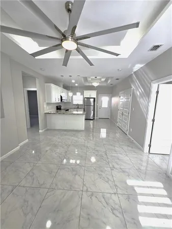 a view of a room with a stove and cabinets