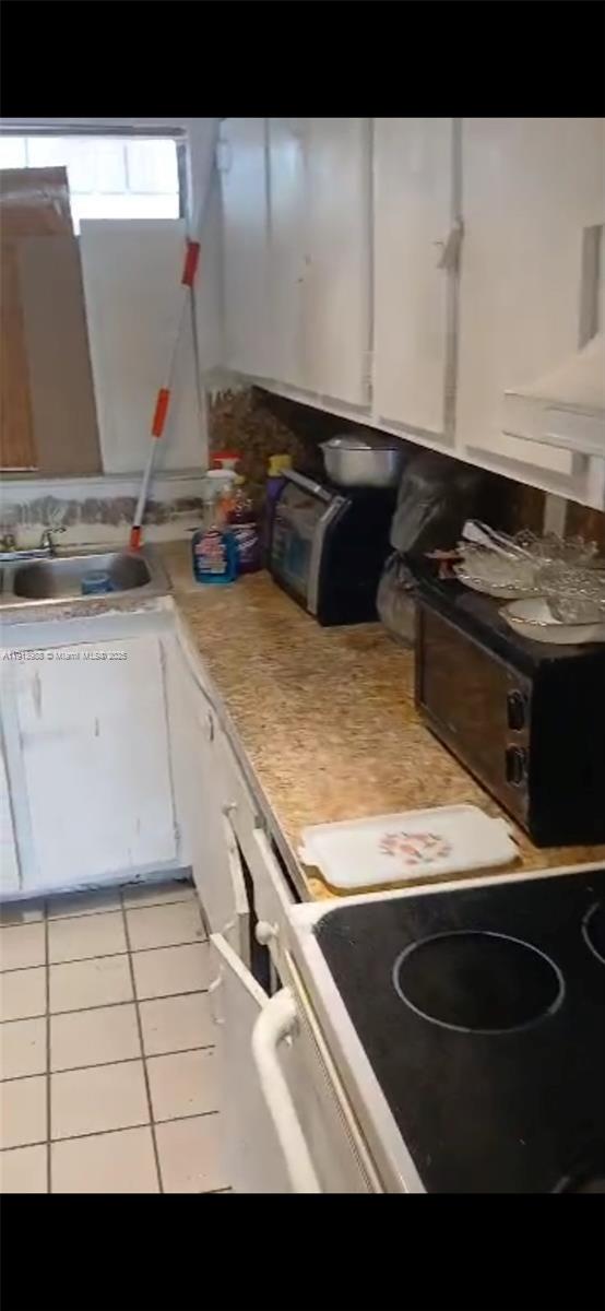 Golden Glades Miami, FL 33161 - Photo 6 of 18 a kitchen with a sink stove and cabinets