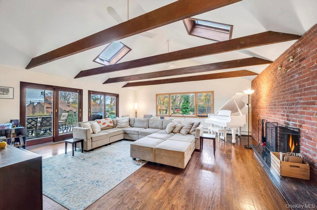 39 Bevin Road Northport, NY 11768 - Photo 17 of 44 Living room with a fireplace, a skylight, and wood finished floors