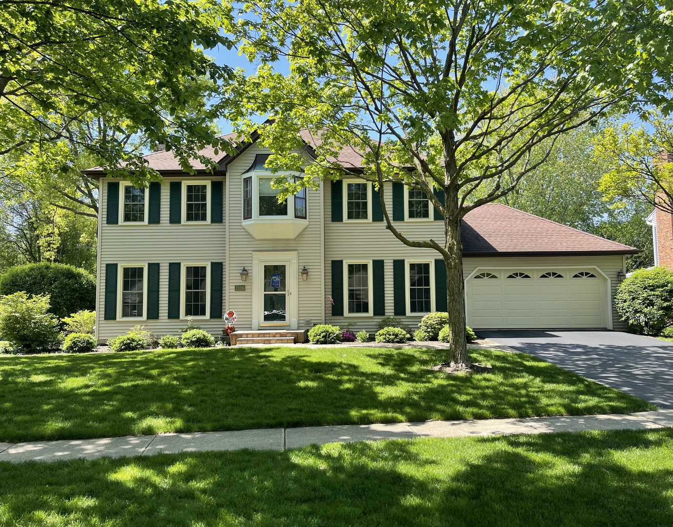 a front view of a house with a yard table and chairs