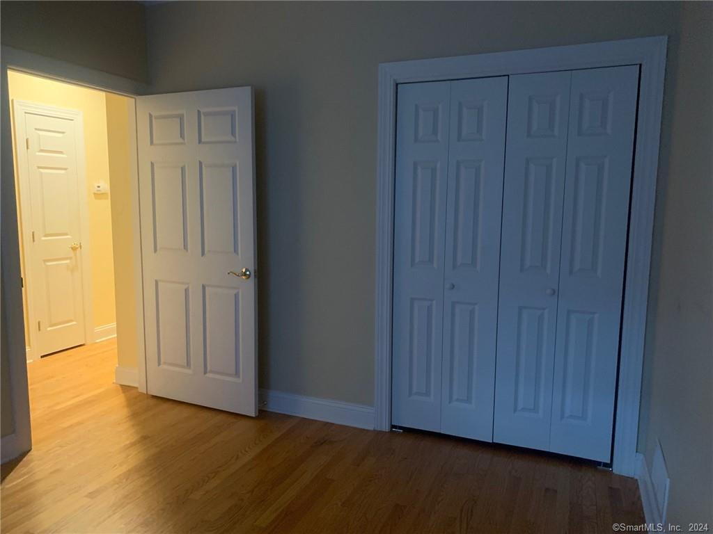 5 Pondview Circle, Unit 5 Beacon Falls, CT 06403 - Photo 16 of 18 a view of an empty room with wooden floor