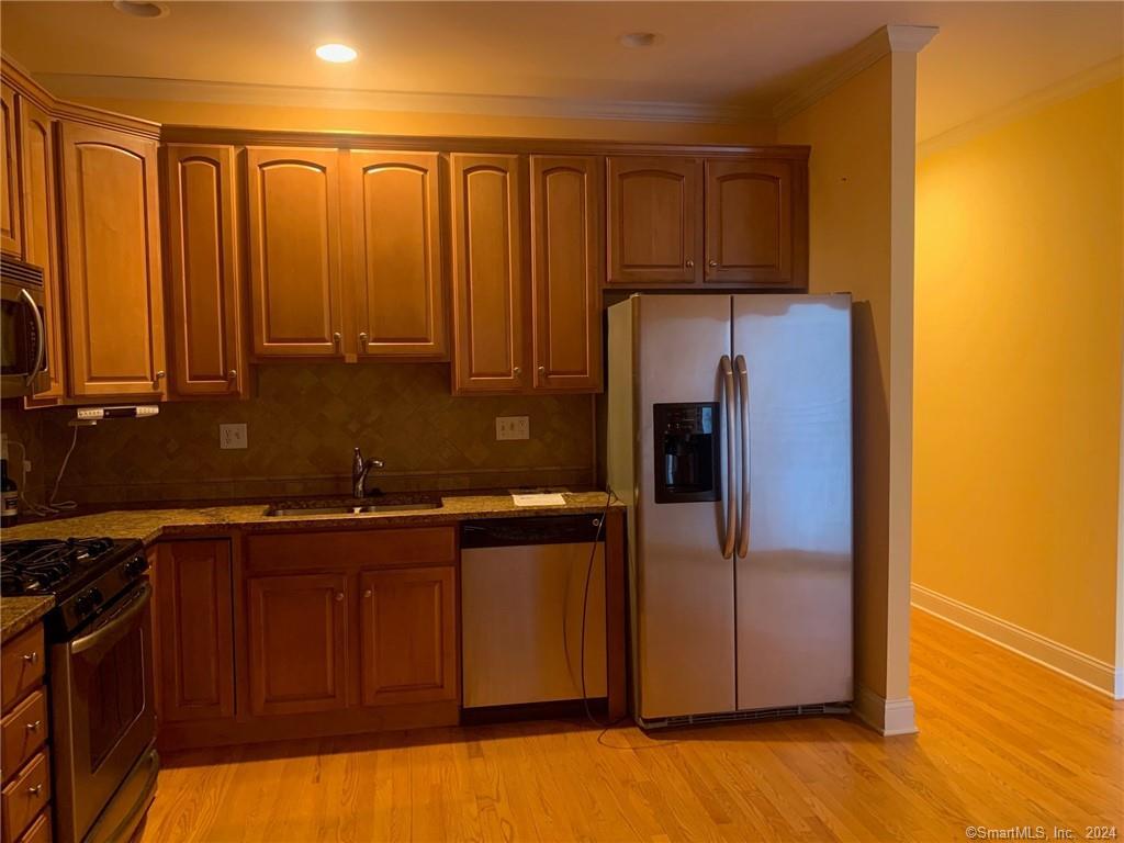 5 Pondview Circle, Unit 5 Beacon Falls, CT 06403 - Photo 7 of 18 a kitchen with stainless steel appliances granite countertop a refrigerator and a sink