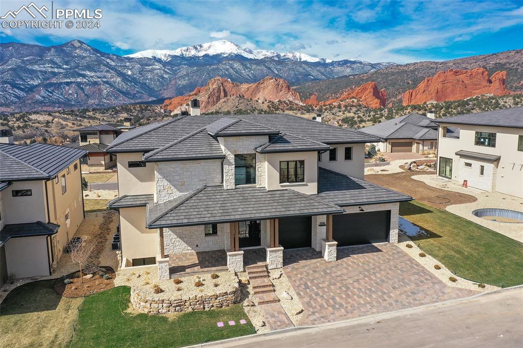 View of front facade with a front lawn and Pikes Peak & Garden of the Gods views