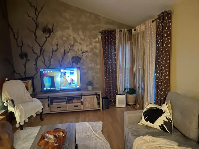 a living room with furniture and a flat screen tv