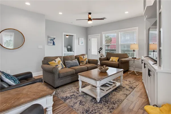 a living room with furniture and a large mirror