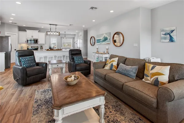 a living room with furniture kitchen view and a table