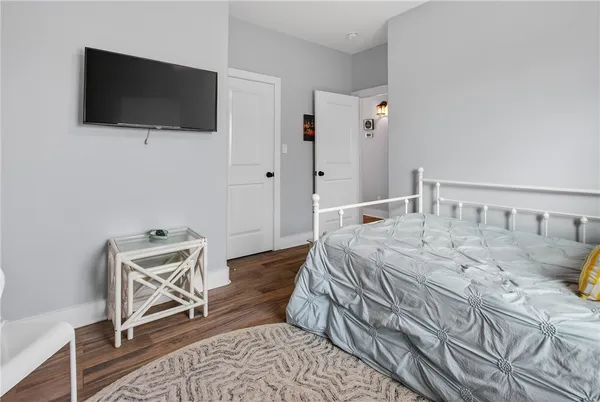 a bedroom with a bed and a flat screen tv