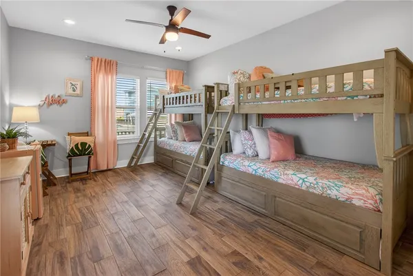 a bedroom with furniture and a wooden floor