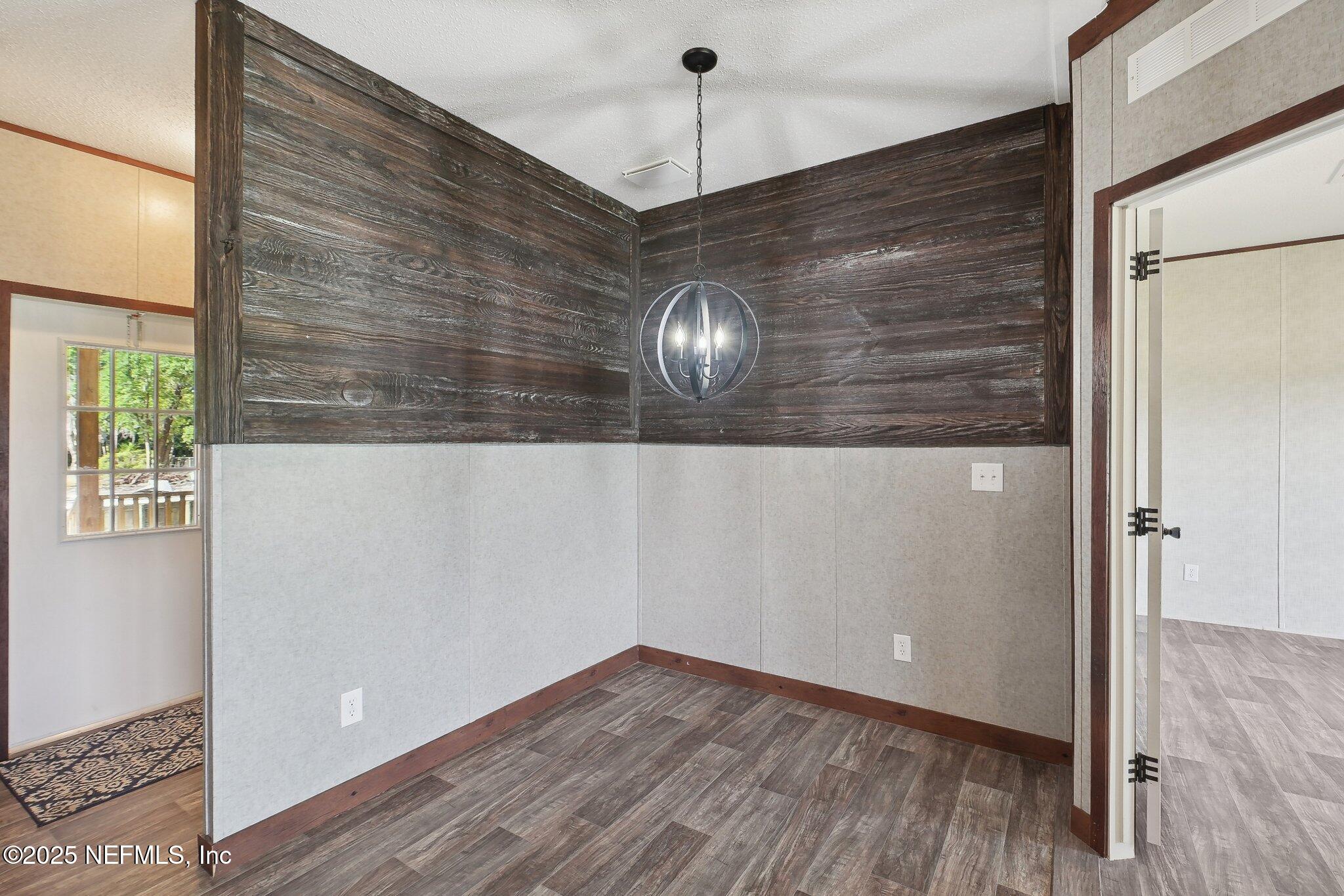 8145 Colee Cove Road St. Augustine, FL 32092 - Photo 13 of 35 a view of empty room with wooden floor