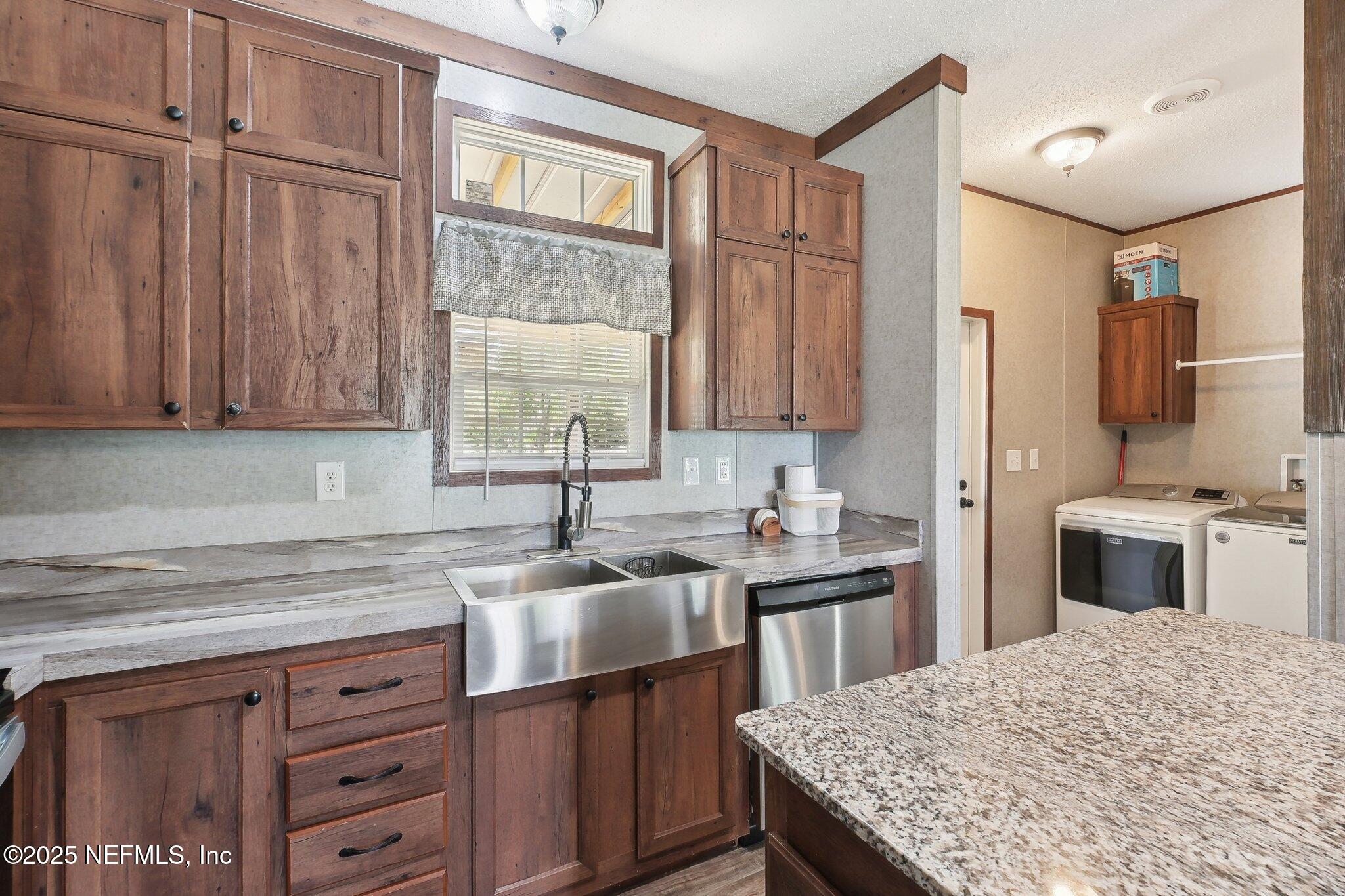 8145 Colee Cove Road St. Augustine, FL 32092 - Photo 16 of 35 a kitchen with a sink stove and cabinets