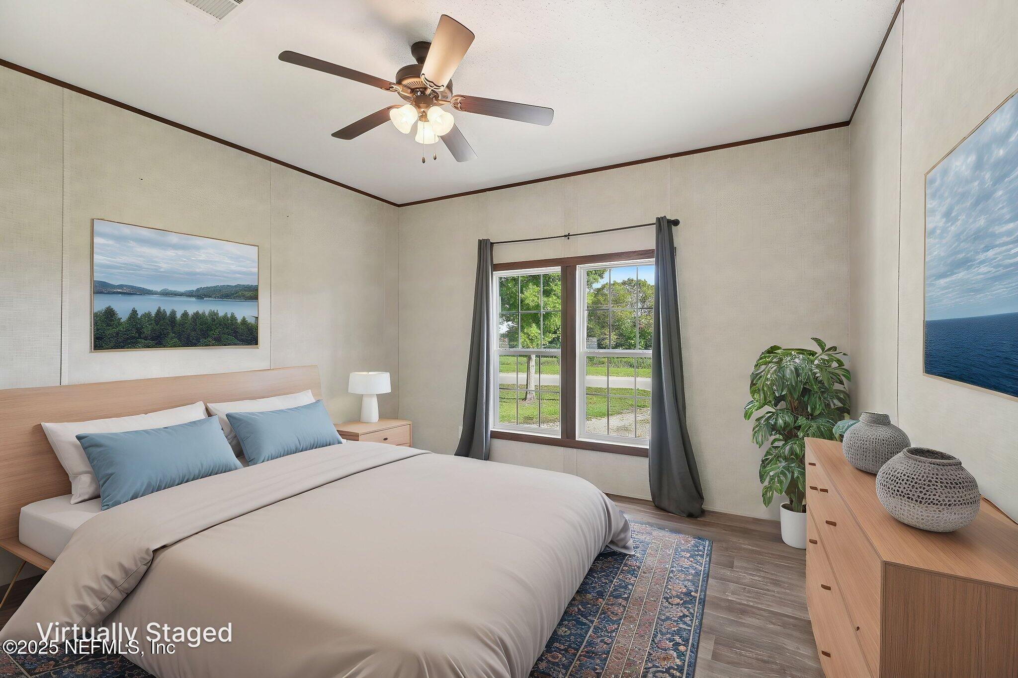 8145 Colee Cove Road St. Augustine, FL 32092 - Photo 17 of 35 a bedroom with a large bed and a chandelier