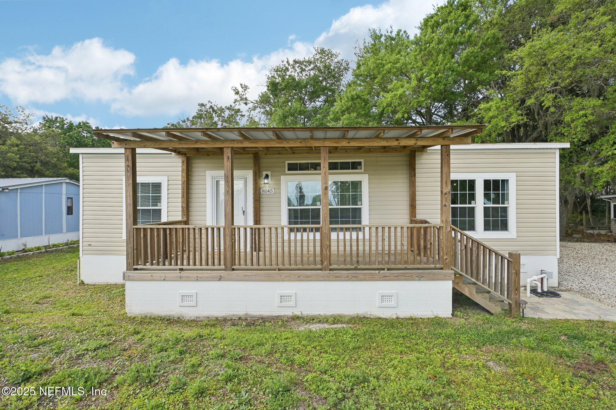 8145 Colee Cove Road St. Augustine, FL 32092 - Photo 2 of 35 a view of a house with a deck and a yard