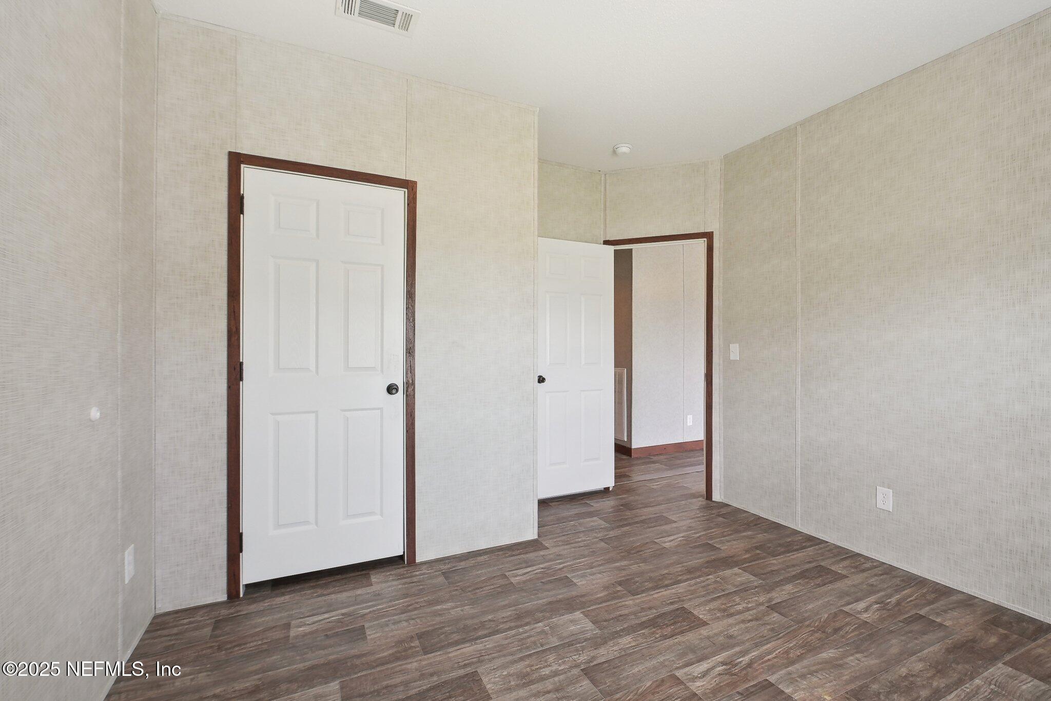 8145 Colee Cove Road St. Augustine, FL 32092 - Photo 21 of 35 a view of an empty room with wooden floor and closet