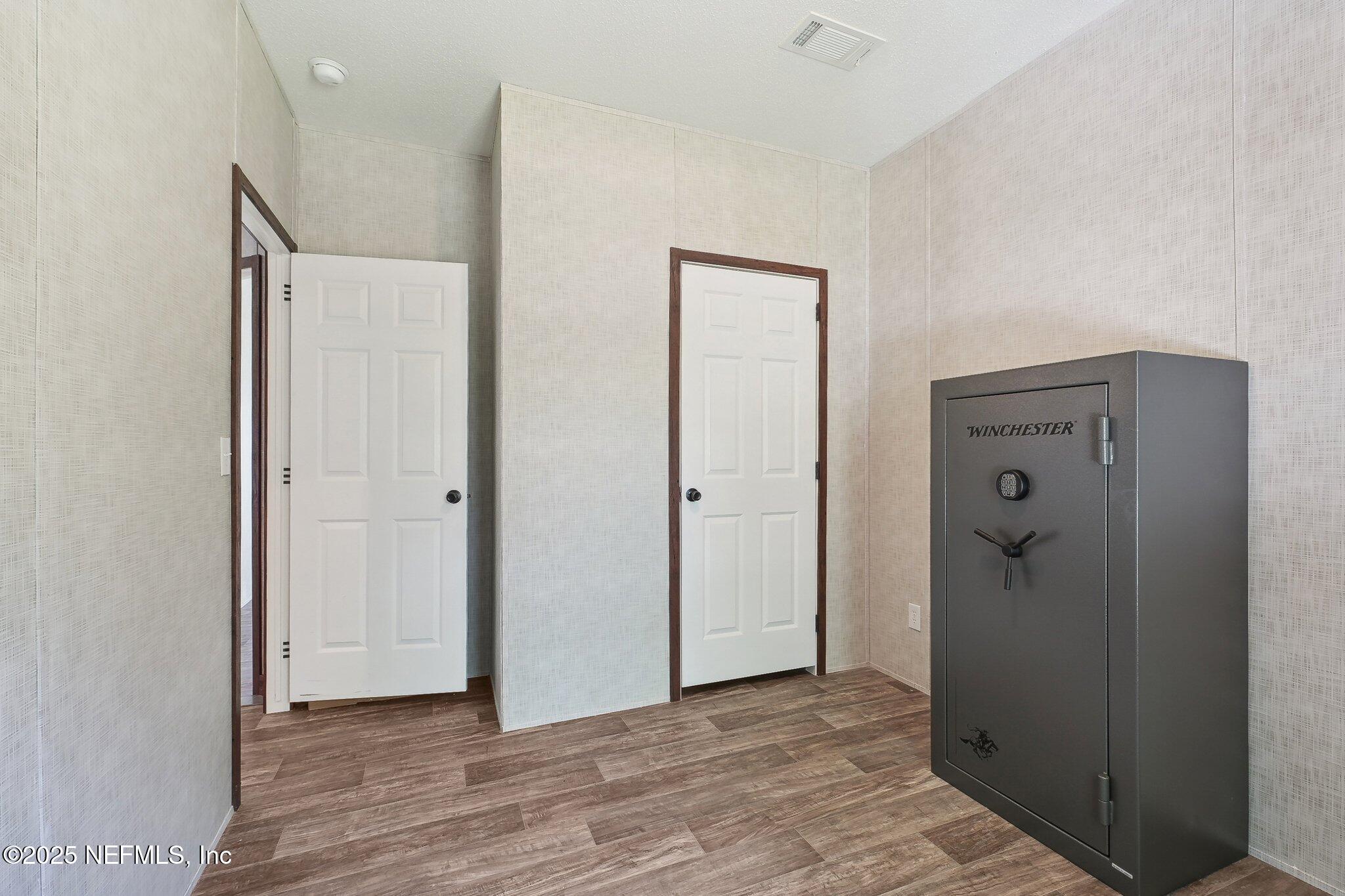 8145 Colee Cove Road St. Augustine, FL 32092 - Photo 23 of 35 a view of a hallway with wooden floor