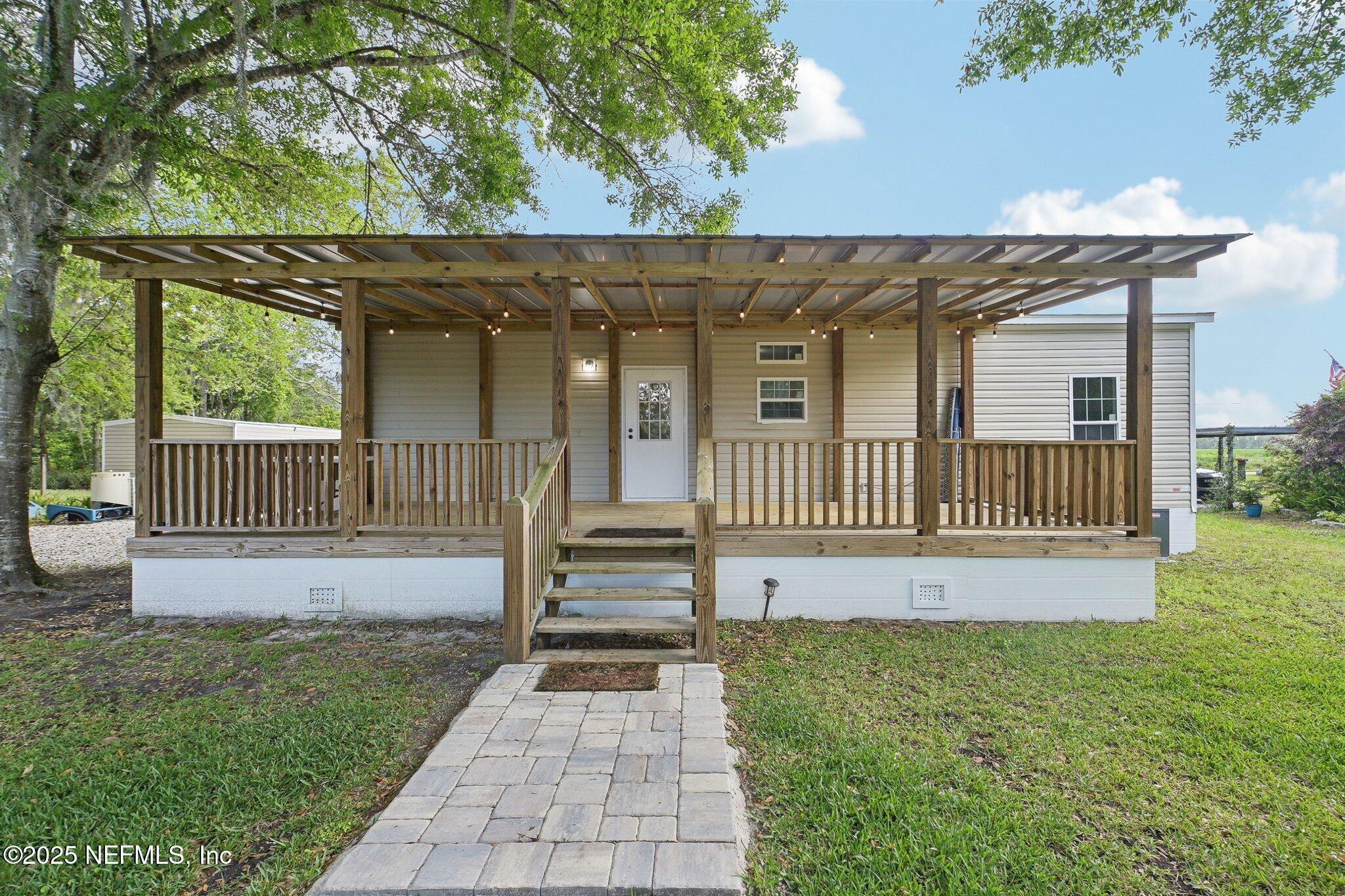 8145 Colee Cove Road St. Augustine, FL 32092 - Photo 29 of 35 a view of a house with a small yard and a garden