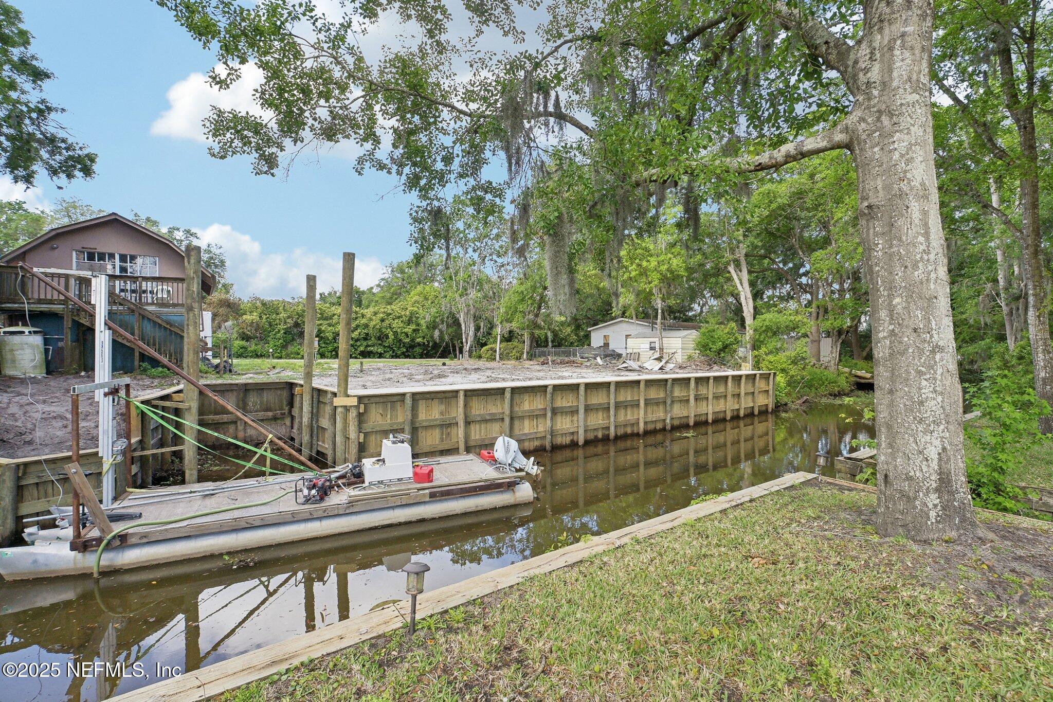 8145 Colee Cove Road St. Augustine, FL 32092 - Photo 6 of 35 a view of house with a small yard and large trees