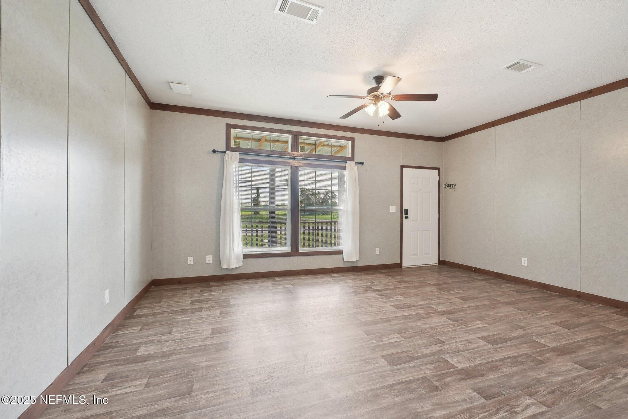 8145 Colee Cove Road St. Augustine, FL 32092 - Photo 10 of 35 wooden floor in an empty room with a window