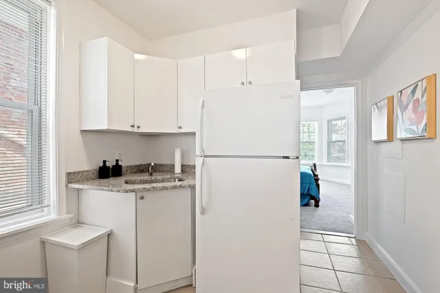 a kitchen with a refrigerator a stove a microwave and cabinets