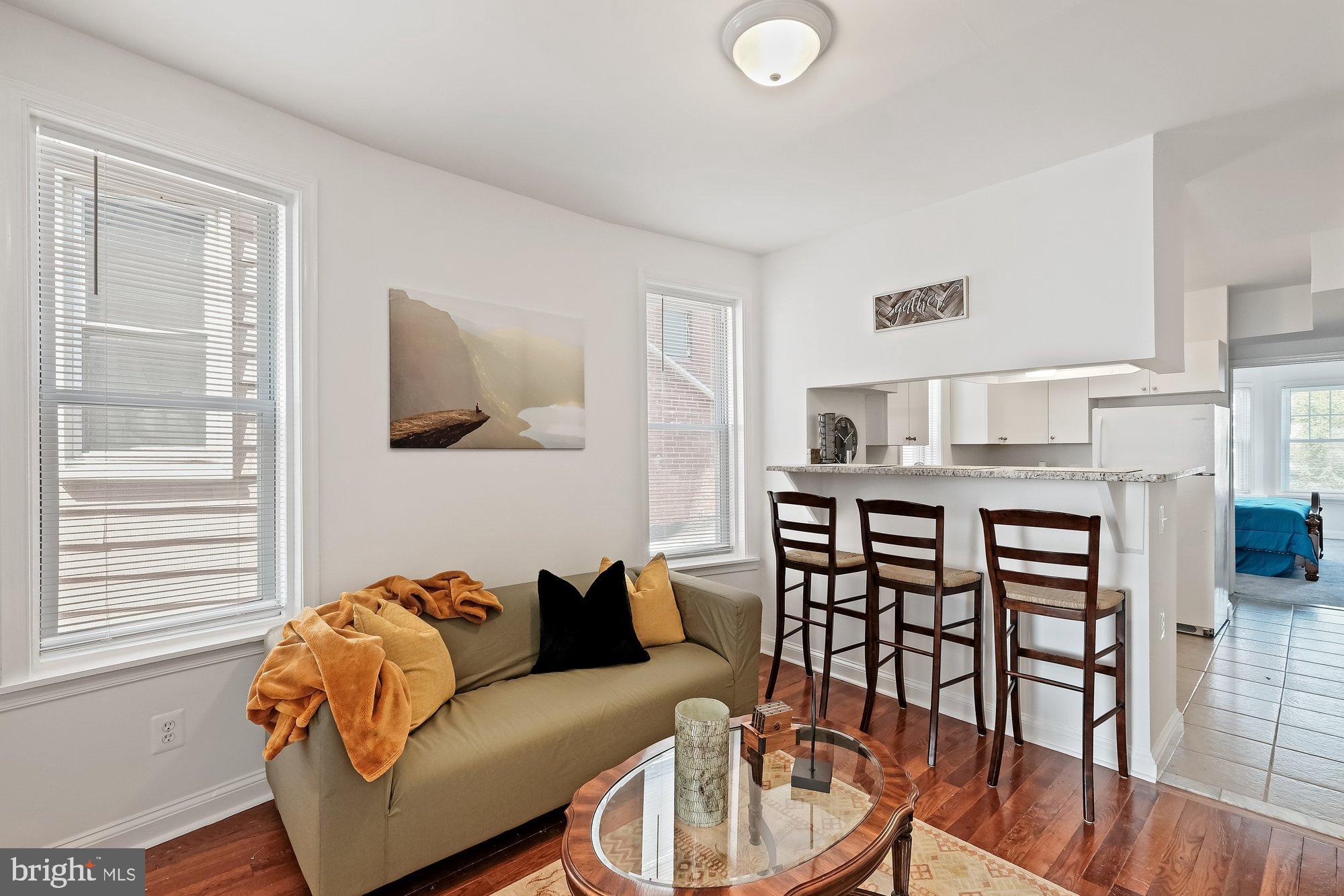 468 East Walnut Lane, Unit 2 Philadelphia, PA 19144 - Photo 8 of 13 a living room with furniture and a wooden floor