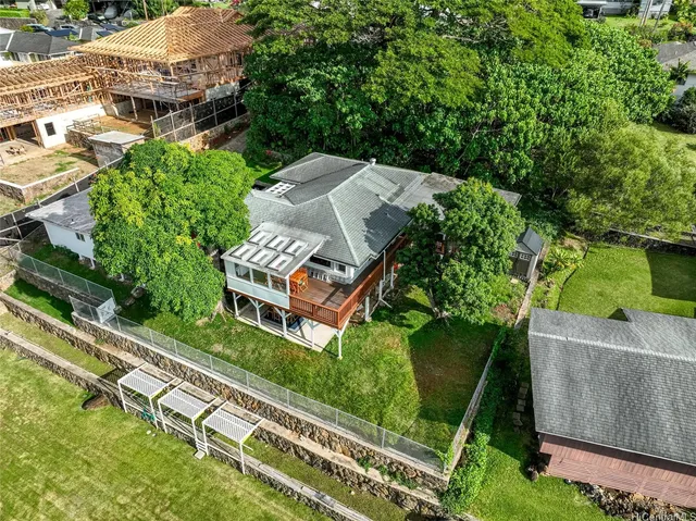 an aerial view of a house with a garden and plants