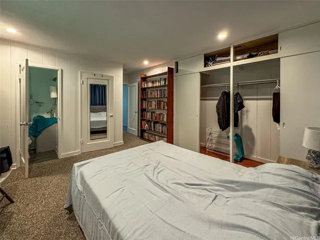 a bedroom with a bed and a walk in closet