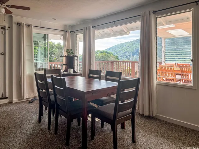 a dining room with furniture window outside view and wooden floor