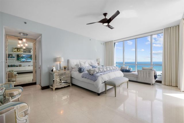 a bedroom with bed and large window