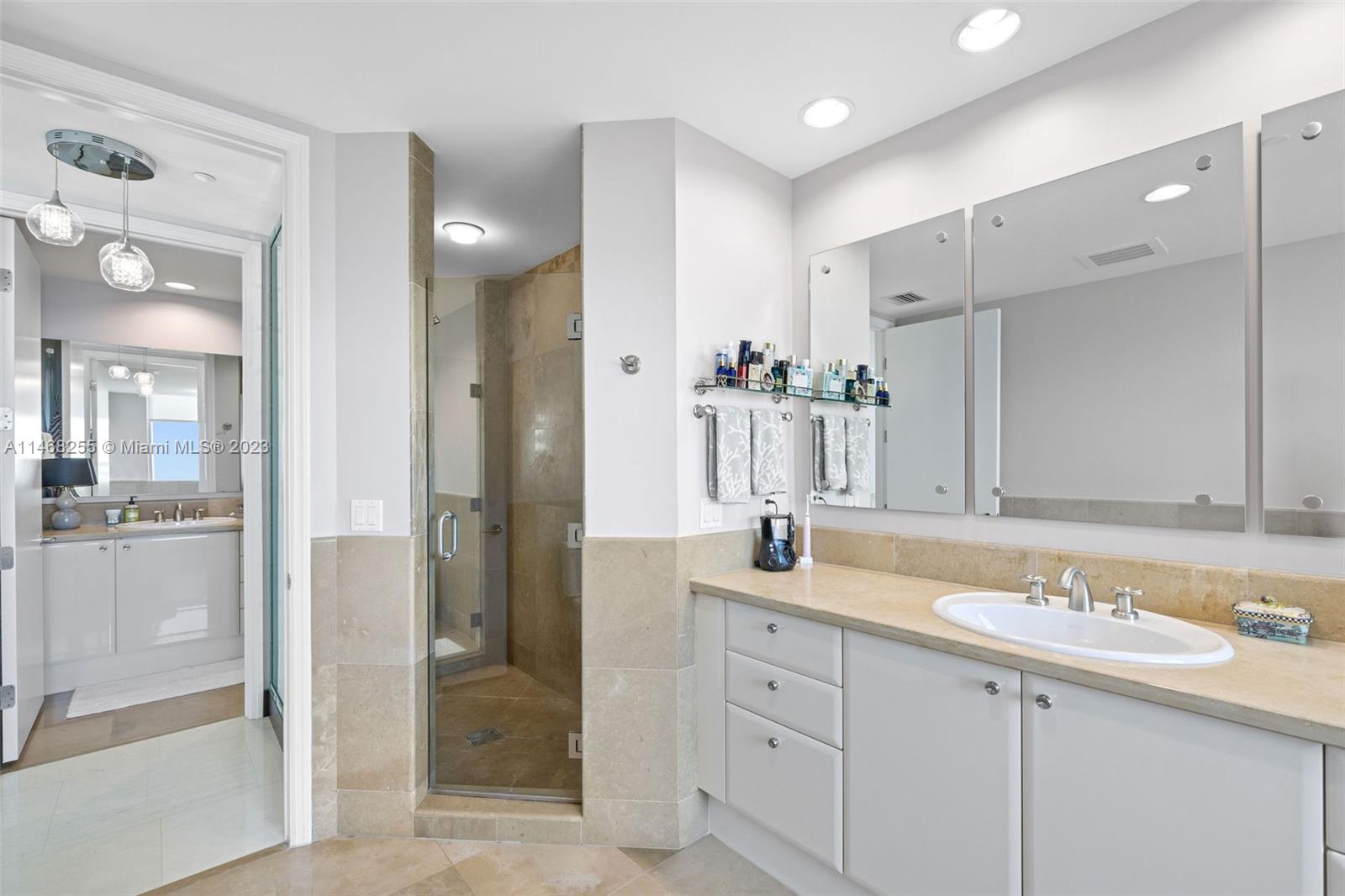 5959 Collins Avenue, Unit 902 Miami Beach, FL 33140 - Photo 22 of 46 a bathroom with a granite countertop sink mirror and double