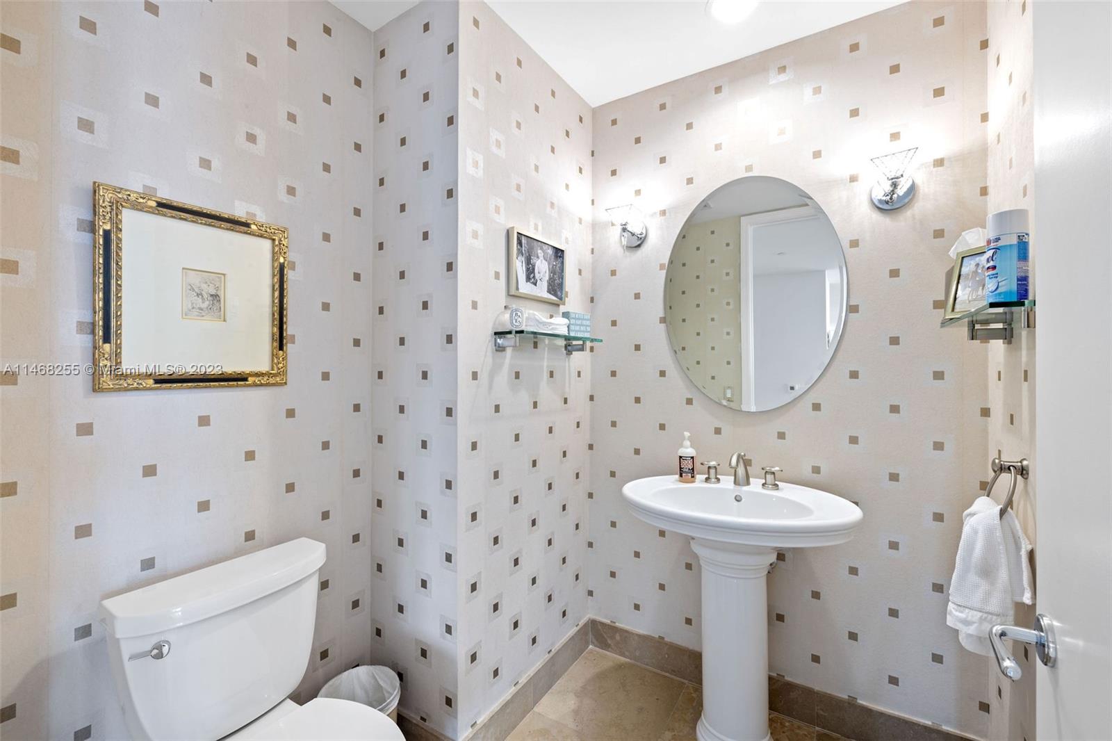 5959 Collins Avenue, Unit 902 Miami Beach, FL 33140 - Photo 33 of 46 a bathroom with a sink mirror and toilet