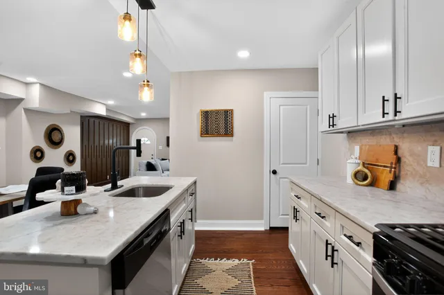 a kitchen with stainless steel appliances granite countertop a sink and a refrigerator