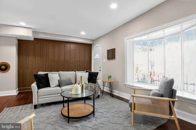 a living room with furniture and a large window