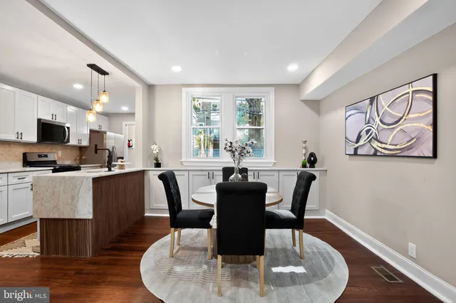 a dining room with furniture a window and wooden floor