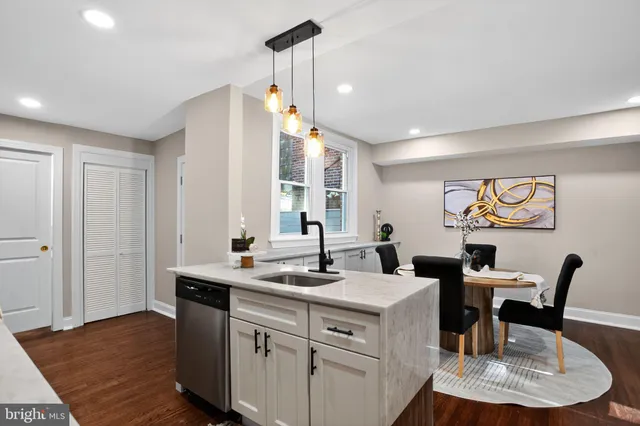 a kitchen with a dining table chairs and white appliances