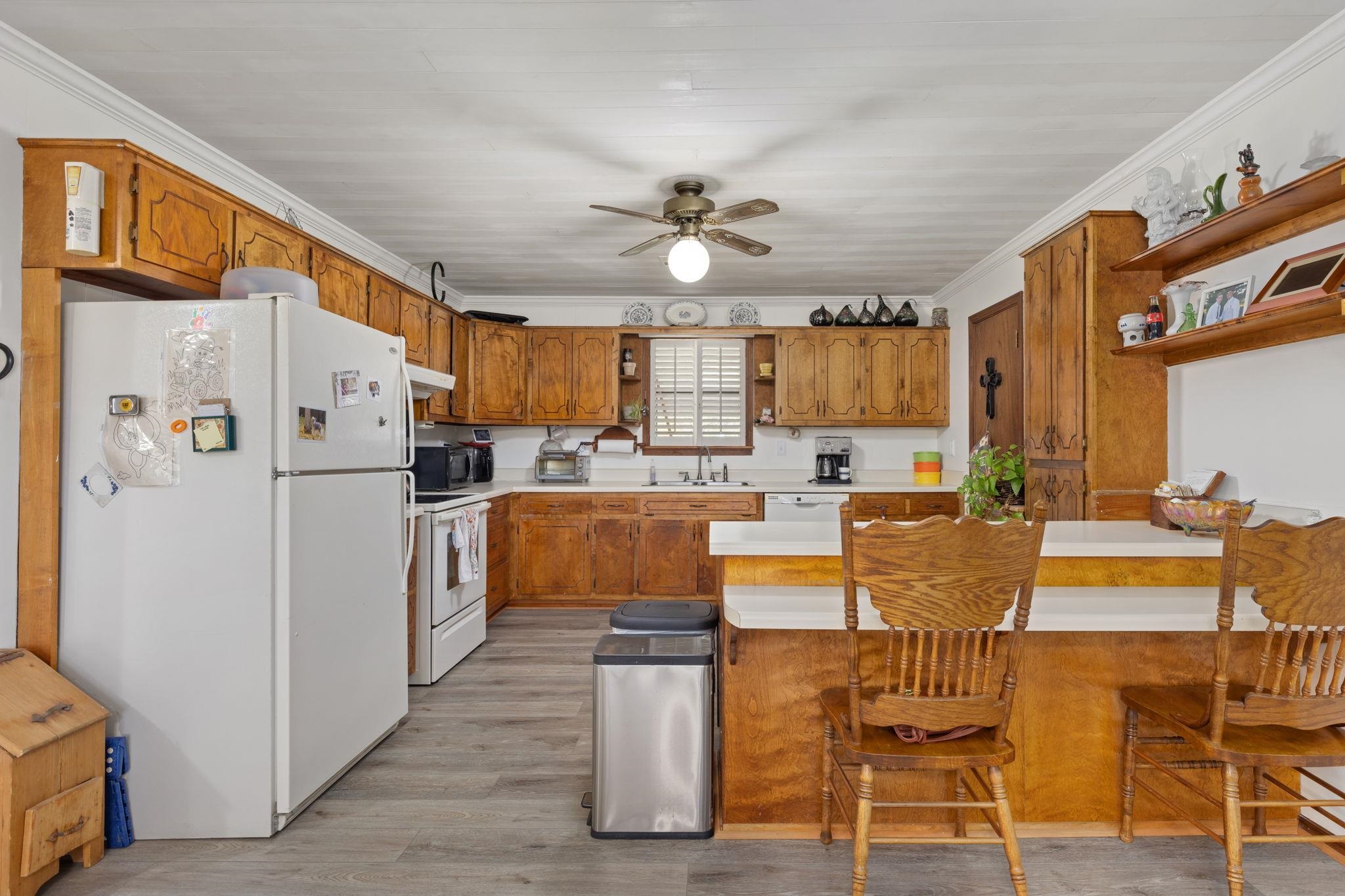 11 Barnstable Road Corinth, MS 38834 - Photo 11 of 40 a kitchen with stainless steel appliances a refrigerator a stove top oven a dining table and chairs