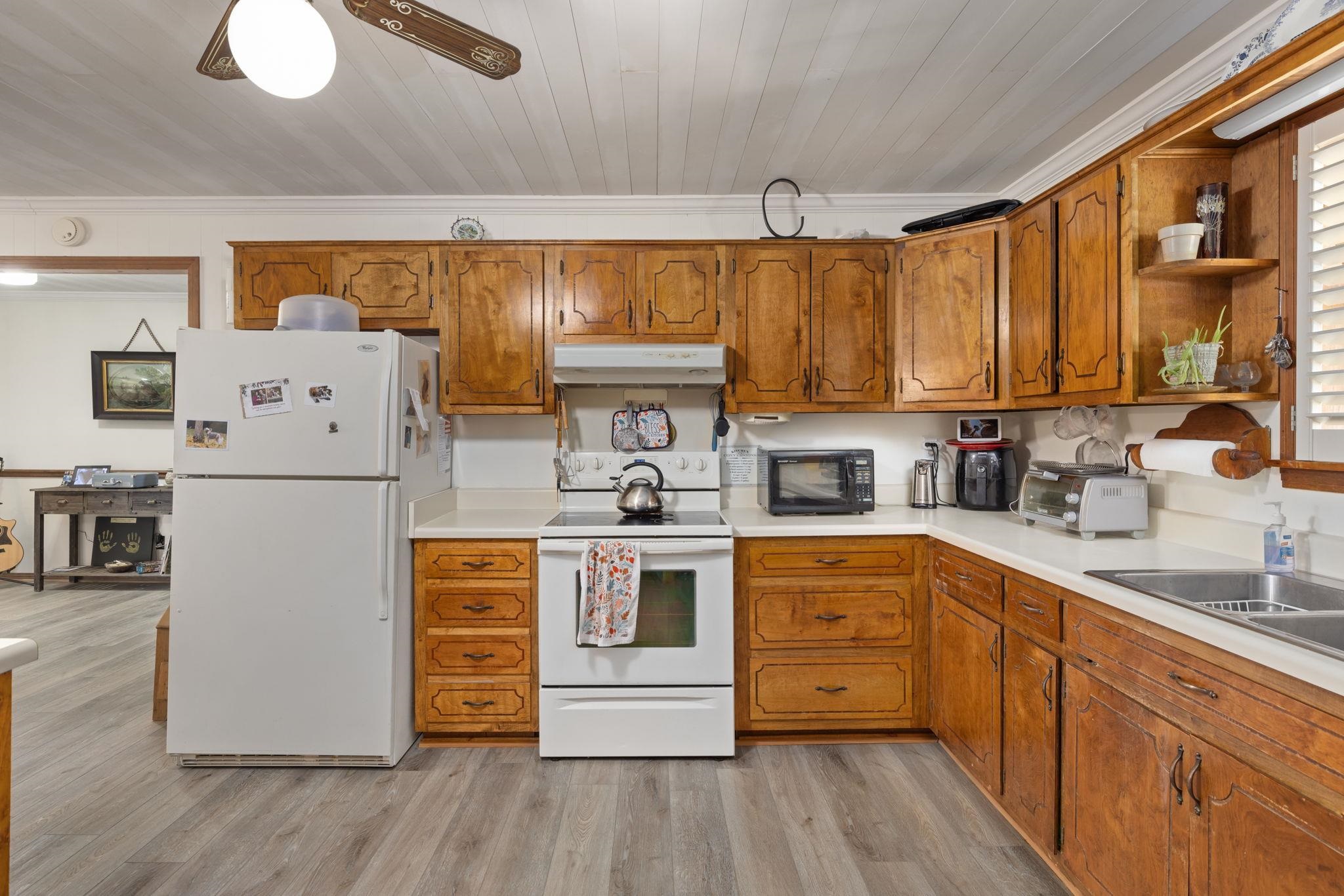 11 Barnstable Road Corinth, MS 38834 - Photo 13 of 40 a kitchen with stainless steel appliances granite countertop a refrigerator a sink dishwasher a stove and white countertops with wooden floor