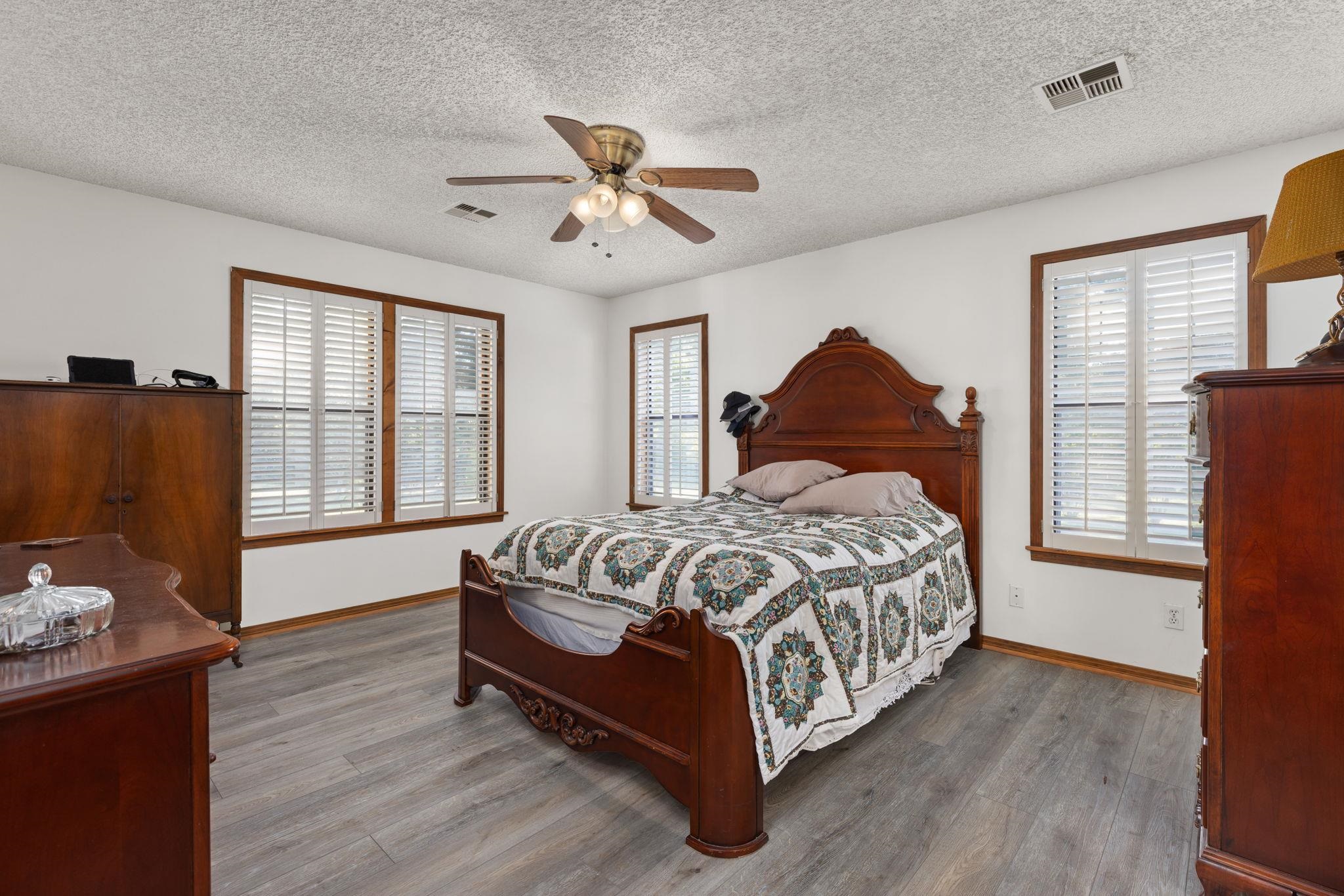 11 Barnstable Road Corinth, MS 38834 - Photo 14 of 40 a spacious bedroom with a bed and wooden floor