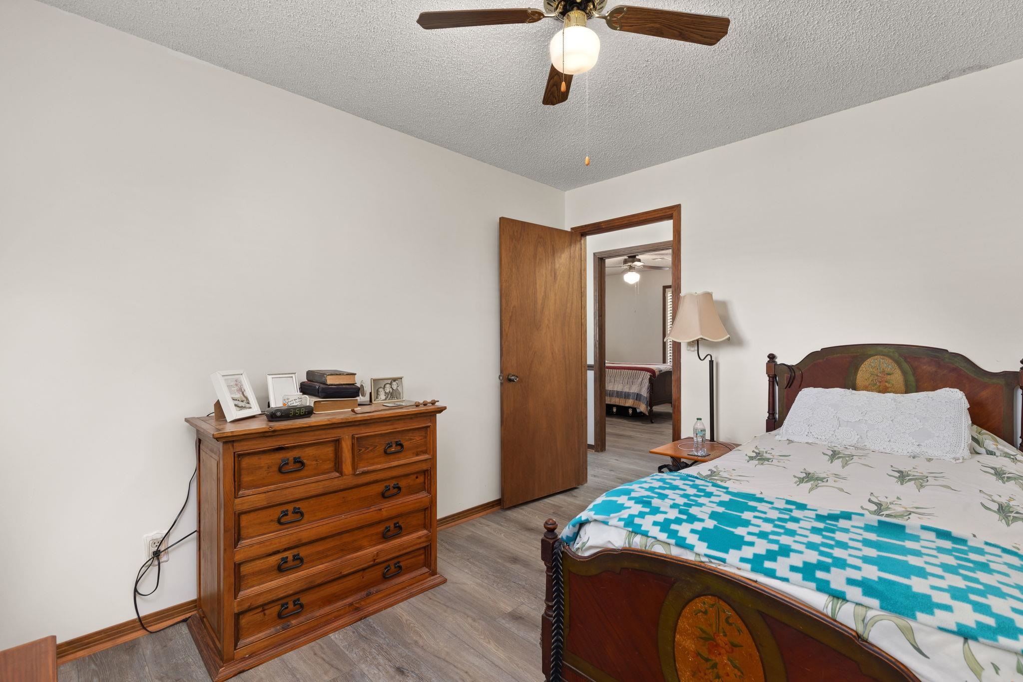 11 Barnstable Road Corinth, MS 38834 - Photo 19 of 40 a bedroom with a bed and dresser with mirror