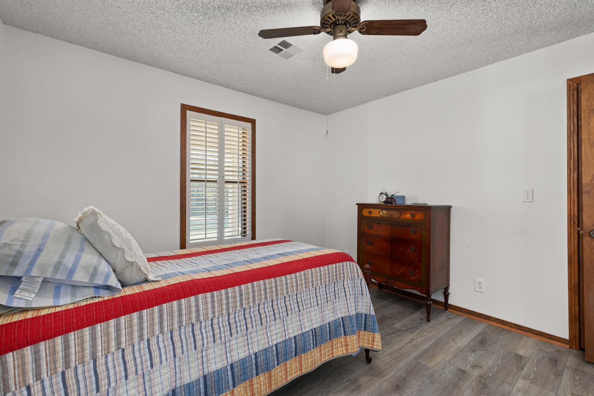 11 Barnstable Road Corinth, MS 38834 - Photo 21 of 40 a bedroom with a bed and a ceiling fan