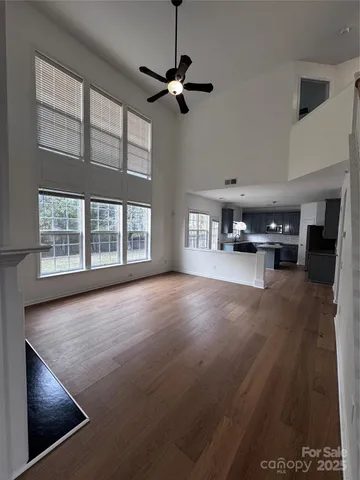 a view of a livingroom with furniture hardwood floor and a ceiling fan
