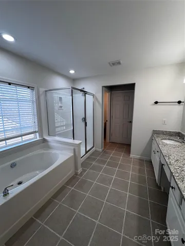 a bathroom with a granite countertop sink a toilet and bathtub