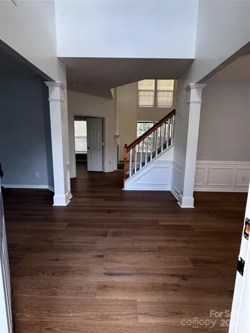 a view of entryway and hall with wooden floor