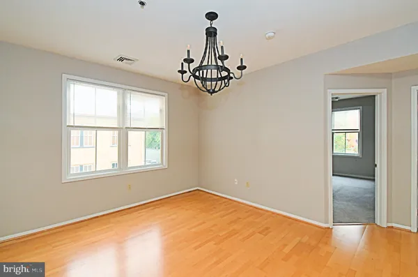 a view of a room with a window and chandelier fan
