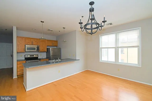 a view of a kitchen with a sink stainless steel appliances and cabinets