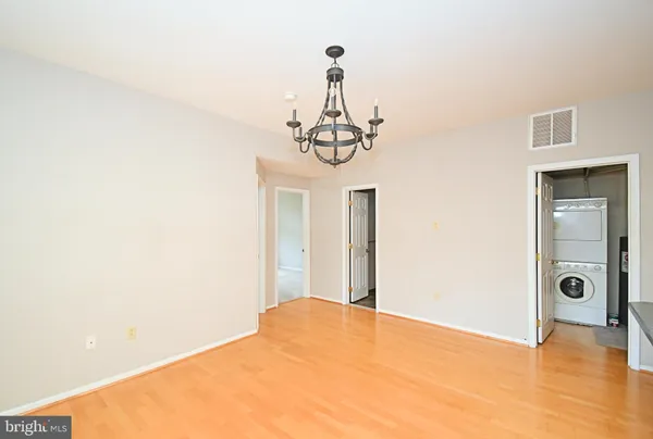 a view of a livingroom with wooden floor and a ceiling fan